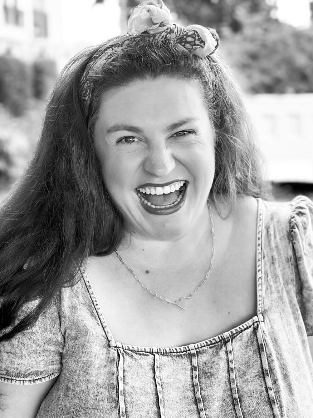 Black and white headshot photo of Caitlyn.